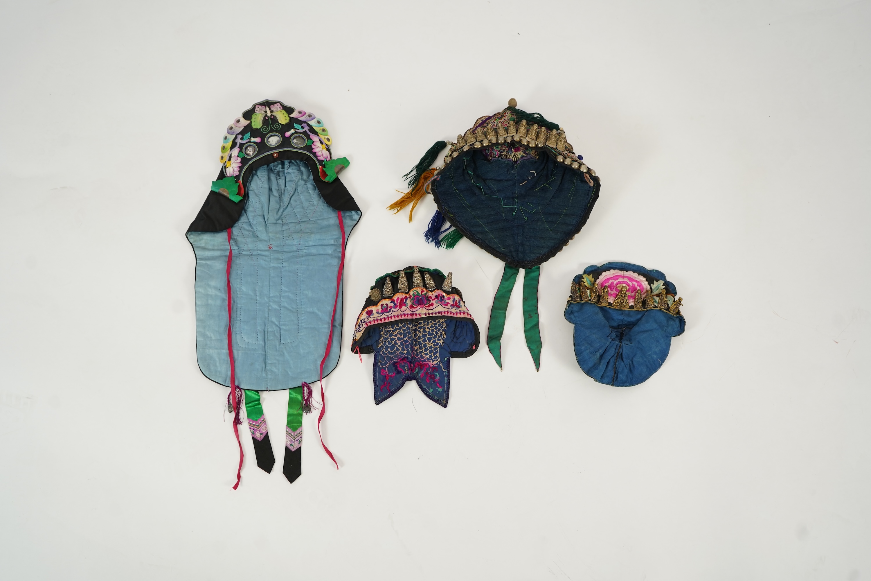 Two Chinese embroidered silk wedding skirts, late Qing, five hats, trousers, two skirt panels and two others, collar and a panel
